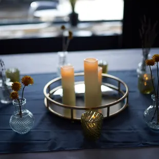 a table setting with candles and flowers