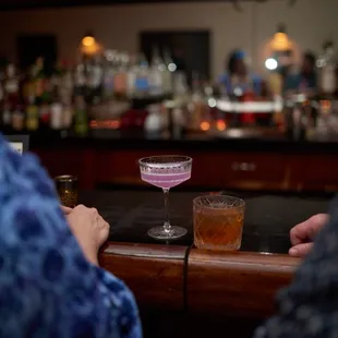 two people sitting at a bar
