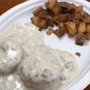 Biscuits and gravy with a side of breakfast potatoes