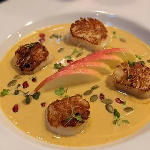 Seared Scallops served over butternut squash bisque with pink lady apples, pepitas, pomegranate &amp; Full-Hand microgreens