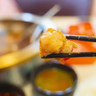 piece of food being held by chopsticks