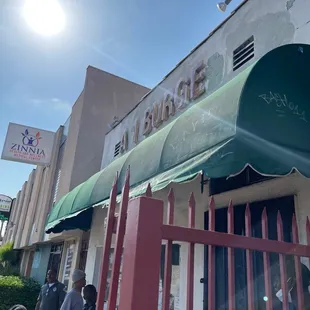 people standing outside of a restaurant