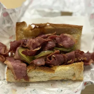 Pastrami extra olive oil pickles on toasted bread
