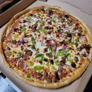Sausage, bacon, green pepper and onion pizza.