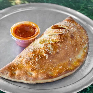  plate of empanadas and a small cup of ketchup