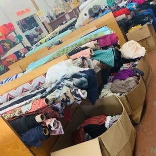 Lots of sales and remnants of material on sale in bottom boxes