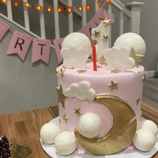 a pink and gold birthday cake