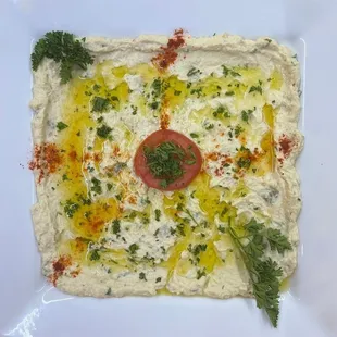 a square of food on a plate