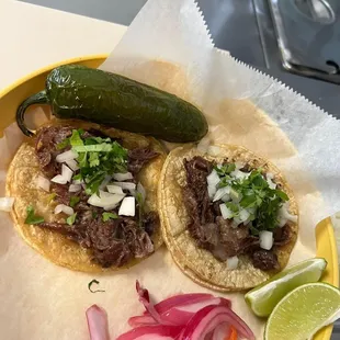 two tacos on a yellow plate
