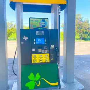 a shamrock - themed atm machine at a gas station