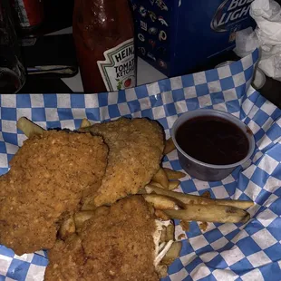 a basket of fried chicken and fries