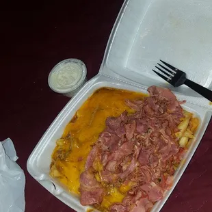 Chili cheese fries with pastrami on one side
