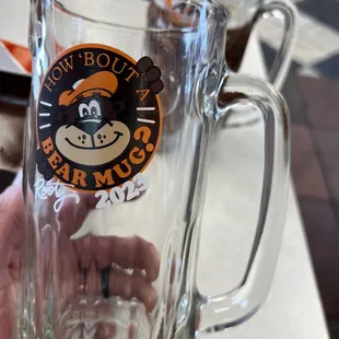 a person holding a glass of beer