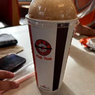 a person sitting at a table with a cup of coffee