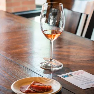 a plate of food and a glass of wine