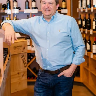 a man standing in a wine shop