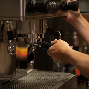a person using a coffee machine