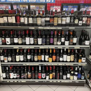 a shelf full of wine bottles