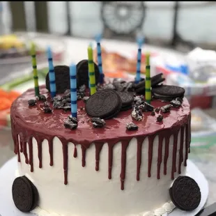 Oreo Cake. White icing/Maroon Icing Drip/Oreo Cookie Crumble!