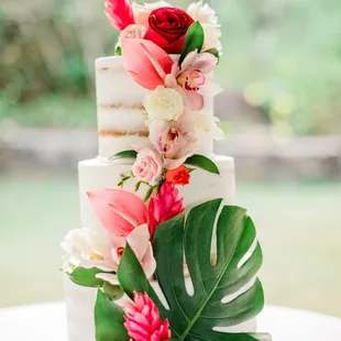 a wedding cake decorated with flowers