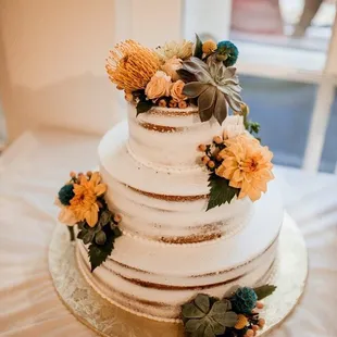 a wedding cake with flowers on top