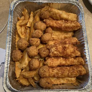 Fish, hush puppies and fries. Also came with separate containers of coleslaw and tarter sauce