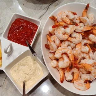 Shrimp cocktail with cocktail sauce fresh lemon and remoulade sauce
