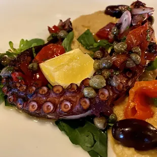 Polipo - Grilled Octopus with Mama Lil&apos;s Peppers, Salsa Verde, Olives, Arugula, and Garbanzo Purée ($15)