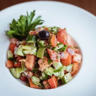 a white plate with a salad on it