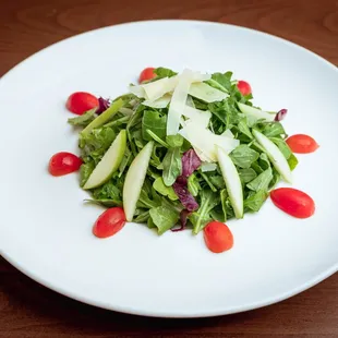 a plate of salad on a wooden table