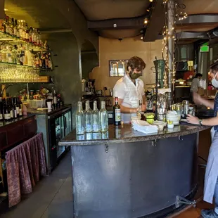 a bartender preparing a drink at a bar