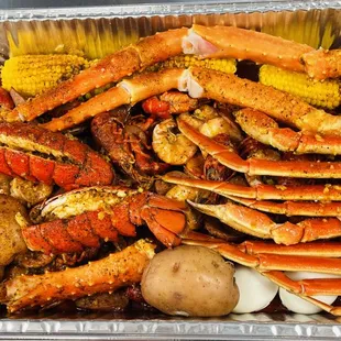  crab legs, corn, potatoes, corn on the cob, and corn on the cob