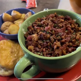 Cup of comfort breakfast bowl with potatoes and a biscuit. Couldn&apos;t finish it!