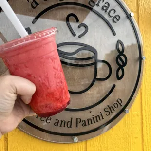 a hand holding a smoothie