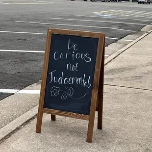 a chalkboard sign on a sidewalk