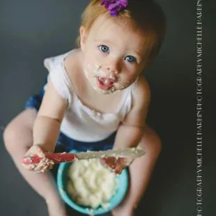 a baby eating cake