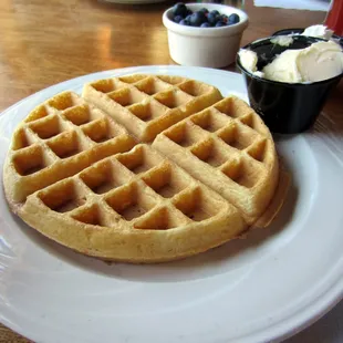 Waffles which came with butter, syrup, whipped cream and berries.