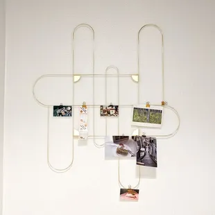 a white wall with pictures hanging on it