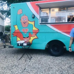 a man standing in front of a food truck