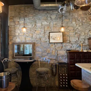 a kitchen with a stone wall