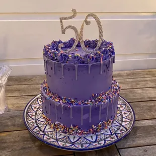 a purple cake with sprinkles