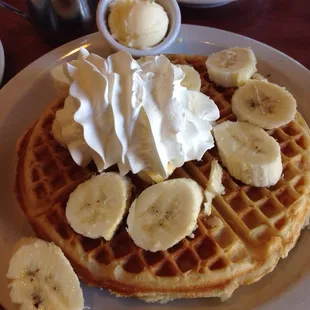 waffles with bananas and whipped cream.