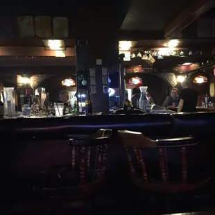 a bar with people sitting at the bar