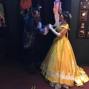 a man and woman dressed as disney characters