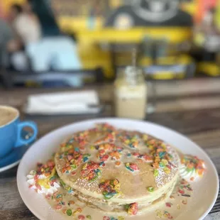 a stack of pancakes with sprinkles