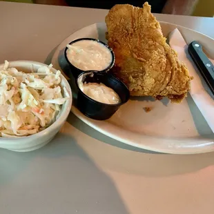 a plate of food and a bowl of coleslaw