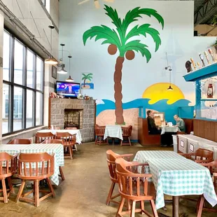 a restaurant with a palm tree painted on the wall
