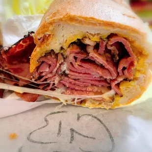 Cross section look at the Aks Hot Pastrami sandwich. Just awesome! +provolone cheese