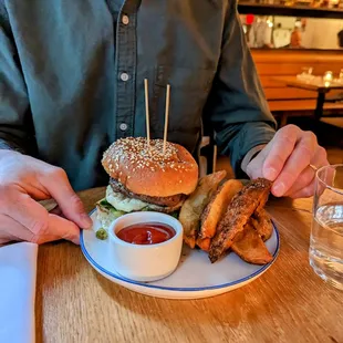  a man sitting at a table with a plate of food