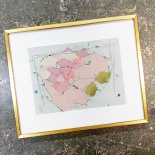 A beautiful Alexis Walter painting with a soft white mat and sleek gold frame.